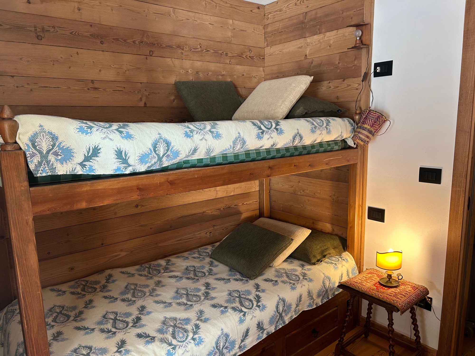 Bunk bed room with wooden paneling