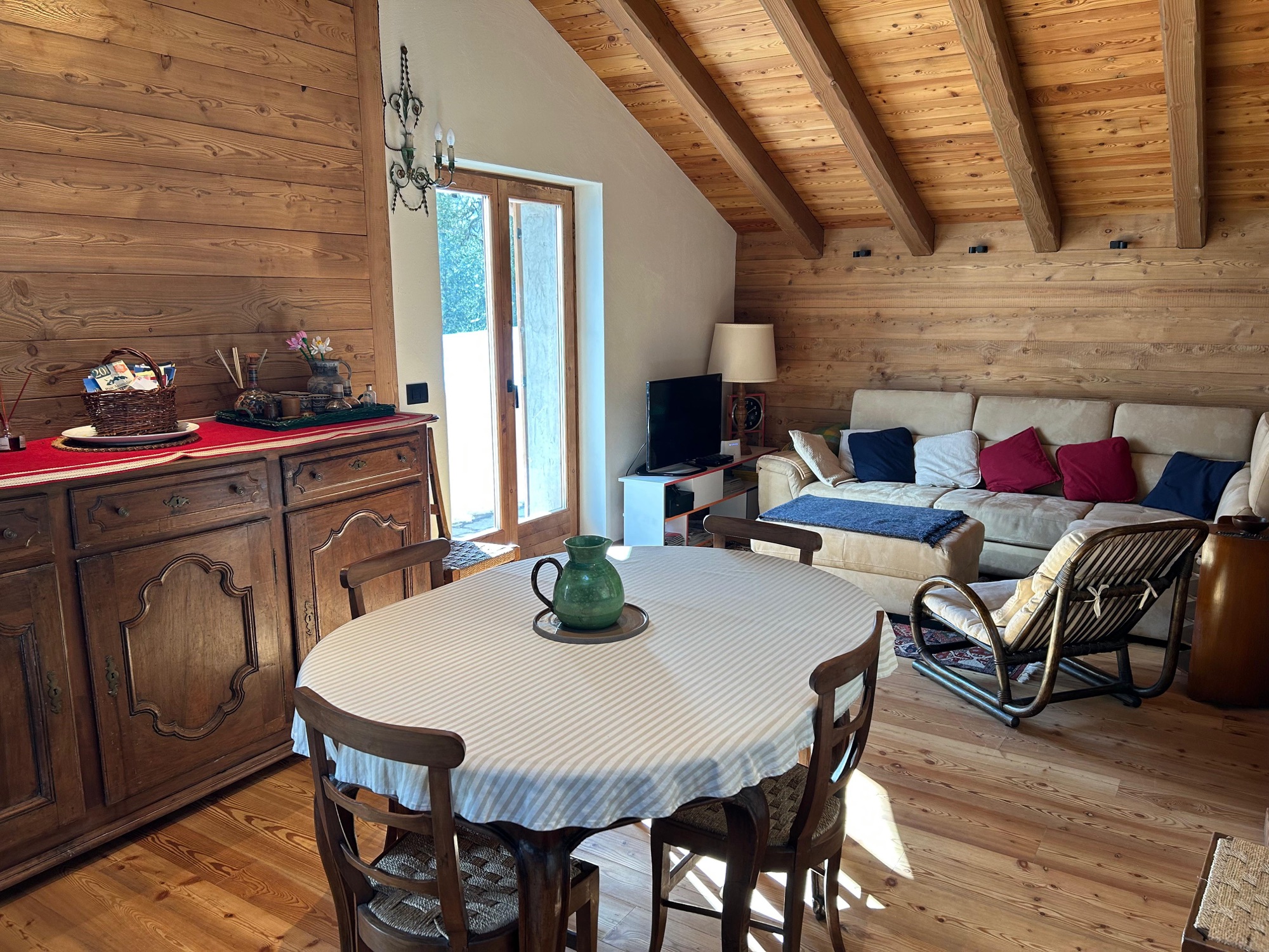 Living and dining area with grand wooden truss